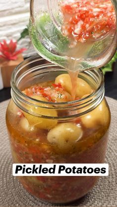 pickled potatoes being poured into a jar