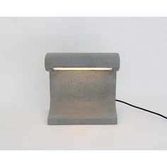 a concrete lamp with a dim light on it