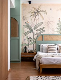 a bedroom with tropical wallpaper and wooden flooring