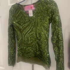 Absolutely Stunning Green Sequined Top. Long Sheer Sleeves. It Is Exquisite. Only Selling Because It Is Too Small For Me. I Knew I Should Have Bought It In A Small, But I Wanted It To Be Form Fitting....And It Is....Just A Little Too Much As It Has Little To No Stretch In It. Bought At A Local Boutique And Can't Return. Original Price Tag Is $249. I Got It On Sale But Not By Much. Sacrificing For $17 As It Is Doing Me No Good Sitting In My Closet. I Am A Size 2-4 So This Would Be Perfect For 0-2 Green Sequin Tops For Fall, Green Stretch Sequined Tops, Green Sequined Stretch Tops, Fitted Green Sequined Blouse, Green Sequined Long Sleeve Top, Green Long Sleeve Sequin Top, Sequined Top, Green Top, Local Boutique