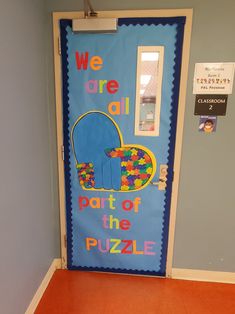 we are all part of the puzzle classroom door decorating it with blue and orange