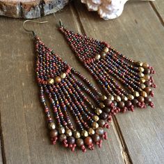 Native earrings Tribal boho brick stitch dangle earrings brown red handmade earrings agueva stone earrings fan jewelry earrings for women Brick stitch beaded earrings in 11/0 seed beads of a brown, dark red, bronze mix of Czech beads, so perfect for summer dresses. I added in some 3mm Czech crystals In bronze and 5mm aqueva Nuevo stone beads, and of course with my original design across top, bronze ear wires. Handmade beaded on durable fire line. Length: 3 inches Brick stitch is an old and rever Handmade Brown Bohemian Beaded Earrings, Southwestern Brown Beaded Earrings For Festival, Southwestern Style Brown Beaded Earrings, Southwestern Brown Dangle Beaded Earrings, Bohemian Brown Beaded Nickel-free Earrings, Earrings Handmade Boho, Native Earrings, Fan Jewelry, Beaded Earring