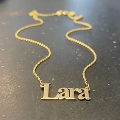 "Handmade 14k solid yellow gold necklace with a custom name pendant of your choosing, layered necklace for women.  This 14k yellow gold necklace truly has your name on it!  This necklace is light and classic, perfect for everyday use. This simple yet sophisticated design will compliment any look you choose. You can wear it as a single, minimalist necklace or layered with more necklaces for a total bohemian look.  Add a little BLING to your everyday look with this shiny solid gold necklace. Featu Customizable Dainty 14k Gold Name Necklace, Customized 14k Yellow Gold Necklace, Dainty Gold Necklace With Custom Name, Dainty Personalized Gold Custom Necklace, Gold Customizable Nameplate Necklace, Customizable Gold Dainty Name Necklace, Customized 14k Gold Nameplate Necklace, Dainty Customizable Gold Name Necklace, Customized Yellow Gold Sterling Silver Name Necklace