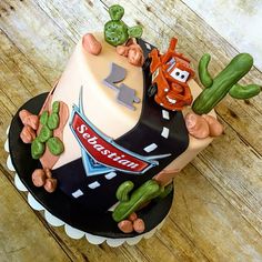 a birthday cake with cars and cactus on top