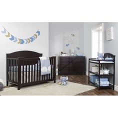 a baby's room with two cribs and a dresser