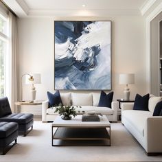 a living room filled with furniture and a large painting hanging on the wall above it