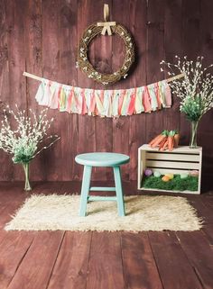 a table with carrots and baby's breath in front of a wooden wall