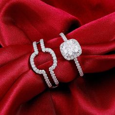 pair of diamond earrings on red cloth