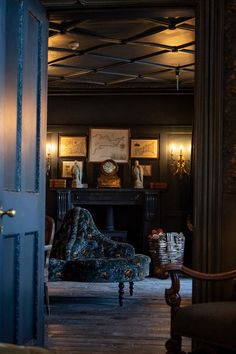 a living room filled with furniture next to a fire place in a building at night