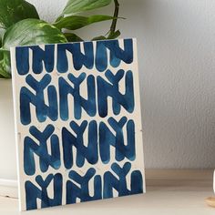 a blue and white ceramic block with the word nynkn on it