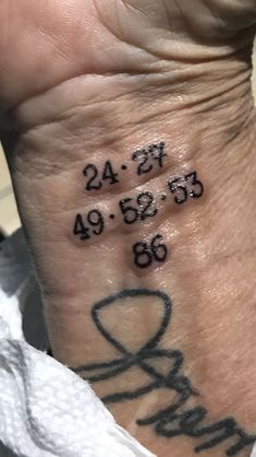 a person with a tattoo on their wrist that reads twenty five and four forty nine