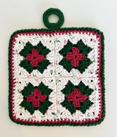 a crocheted pot holder with poinsettis on it