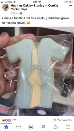 a person holding a cookie shaped like a baby's body in a plastic bag