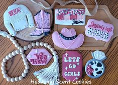 decorated cookies and other items on a wooden table with words that read, let's go girls