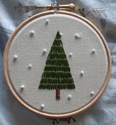 a hand embroidered christmas tree on a white background