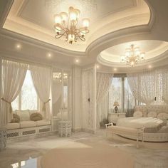 a bedroom with white furniture and chandelier in the ceiling, along with large windows