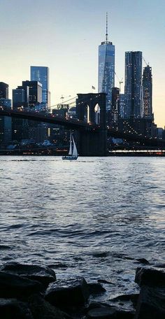 there is a sailboat that is in the water and some buildings are in the background