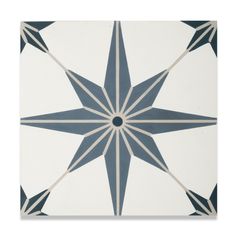 a white and blue tile with an intricate star design on the bottom half of it