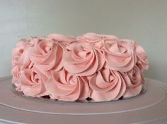 a cake with pink frosting flowers on top