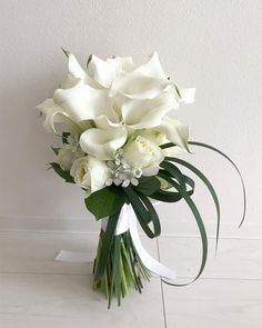 a bouquet of white flowers sitting on top of a table