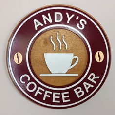 a sign that says andy's coffee bar with a cup of coffee on it