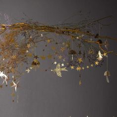 an image of christmas decorations hanging from the ceiling with gold stars and snowflakes