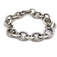 "This is an authentic chain bracelet is by David Yurman, it is crafted from sterling silver featuring large oval links in alternating pattern of cable style silver links with oval polished links. It secures with an invisible oval link hook clasp, and it is signed by the designer with the silver content. Material:  sterling silver Hallmark:  D.Y 925  Measurements:  7.75\" to 8\" long x 0.50\" wide x 0.45\" high Weight:  34.9 grams Stock# 68118" Luxury Bracelet With Cable Chain And Oval Link, Luxury Bracelets With Cable Chain And Oval Link, Classic Sterling Silver Bracelet With Chunky Chain, Classic Sterling Silver Bracelet With Chunky Oval Links, Silver Oval Link Chain Bracelet With Cable Detail, Silver Cable Chain Bracelet With Oval Links, Classic Sterling Silver Bracelet With Cable Chain, Silver Oval Link Chain Bracelet, Sterling Silver Oval Link Chain Bracelet