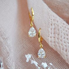 "Gold Teardrop Earrings // Boho Bridal Earrings // Short Drop Earrings // April Birthstone Earrings // Crystal Earrings // Bridesmaids Earrings // Hoops Dainty crystal teardrop earrings set with gold bezels and secured to small shiny gold plated hoops or delicate 14k gold filled earring hooks. Whether searching for boho bridal earrings for your wedding day or something for your bridesmaids your beautiful crystal earrings will arrives suitably gift wrapped ready for gift giving.  Measurements: The size of the hoops are approx. 12mm The teardrop earrings hang approx. 1\" length for both styles Metals: 14k gold plated teardrops 18k gold plated hoops // Nickel & Lead-Free //or// 14k gold filled earring hooks Complete the look with a matching teardrop necklace: https://www.etsy.com/listing/1169 Party Dangle Huggie Earrings, Gift Drop Bridal Earrings With Ear Wire, Pierced Teardrop Bridal Earrings As Gift, Dainty Teardrop Huggie Earrings For Wedding, Teardrop Clip-on Earrings For Wedding, Teardrop Crystal Earrings For Pierced Ears Gift, Teardrop Crystal Earrings Gift, Dainty Teardrop Earrings For Party, Elegant Teardrop Crown Earrings As Gift