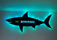 Personalized Great White Shark with or without lights This kids Great White Shark is personalized with your littles name. It can either used as a bedroom door hanger, nightlight or wall art for any room. You can choose with or without lights. Lights are fairy lights and will already be attached for easy set up. These lights are dual with battery operated and well as USB hook up to be able to be mounted anywhere even if you don't have an outlet nearby. Each sign will be ready for hanging 1/2 thic Shark And Dinosaur Bedroom, Kids Shark Bedroom, Toddler Shark Room, Shark Themed Bedroom Boy Rooms, Boys Shark Room, Shark Bedroom Boys, Baby Shark Bedroom, Boys Shark Bedroom, Boys Ocean Bedroom