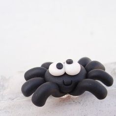 a black and white spider brooch with eyes