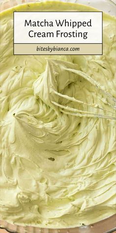 a bowl filled with cream frosting on top of a wooden table