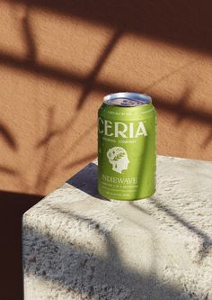 a can of beer sitting on top of a cement block