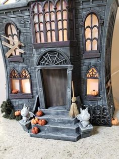 a halloween house with pumpkins and witches outside