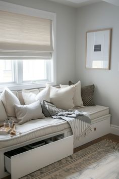 a white couch sitting under a window in a living room