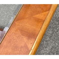 a cat is sitting on the floor looking at its reflection in the glass door frame