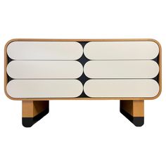 a white and black sideboard with three wooden legs