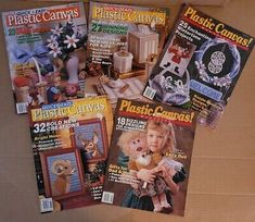 four magazines sitting on top of a cardboard box