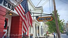 an american flag hanging from the side of a building