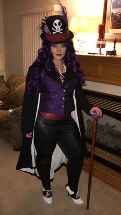 a woman dressed as a pirate holding a cane