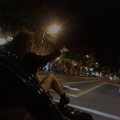 a person sitting in the passenger seat of a car at night