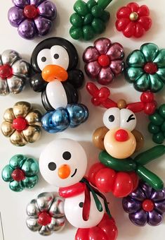 christmas decorations made out of plastic balls and balloons are arranged in the shape of snowmen