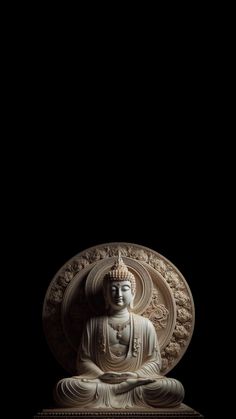 a buddha statue sitting in the middle of a dark room with black walls and flooring