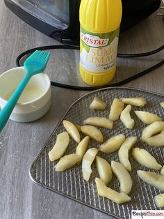 peeled bananas on a cooling rack next to a toaster and bottle of mayonnaise