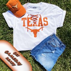 "Texas longhorn game day tee with a new twist on an ordinary tee.  The v-neck is cut out, little holes are cut to thread the knit burnt orange lace up.  You can leave the tee long, have it cut off or cut with a front tie.  At check out, you can choose from original hem, crop (21\" from back neck line) or crop with front ties. If you would like grommets to line the v-neck instead of little holes, please include that on your order by typing your request.  100% cotton tee, machine wash, line dry.  Made in Texas with ❤️! https://seamsewdistinctive.etsy.com/listing/1588296750" Texas Longhorn Shirt Ideas, Longhorns Game Day Outfit, White T-shirt For Summer Fan Gear, Texas Longhorns Game Day Outfit, Texas Longhorns Shirts, Longhorns Football, Original Hem, Texas Longhorn, Texas Longhorns