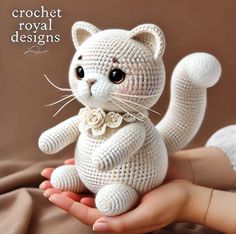 a crochet cat sitting on top of someone's hand with the caption crochet royal designs