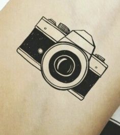 a camera tattoo on the back of a person's arm