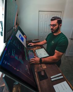 a man sitting at a desk with a laptop and calculator in front of him