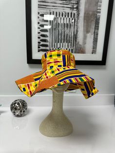 Enjoy our over sized African print sun hat this summer!! Hat with its wide range brim makes it very useful as a beach hat without compromising on fashion! Your Ankara hat is not too big or too small; Just the right statement piece! Not crazy about the beach? Wear it to your cookouts or fun garden party or outdoor festivals with your favorite solid colored outfits. *Hats will arrive folded and can be ironed to take any creases out or wear it just the way it falls with folds. *Lighting may alter c Fun Wide Brim Bucket Hat For Summer, Fun Multicolor Wide Brim Bucket Hat, Fun Curved Brim Bucket Hat For Beach, Fun Fedora Beach Hat, Fun Beach Fedora Hat, Adjustable Multicolor Sun Hat, Multicolor Sun Hat For Beach, One Size Fits Most, Multicolor Sun Hat For The Beach, Fun Fedora Sun Hat For Vacation