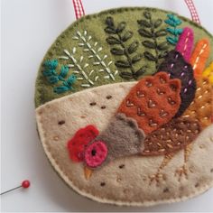 a close up of an ornament made out of felt with birds on it