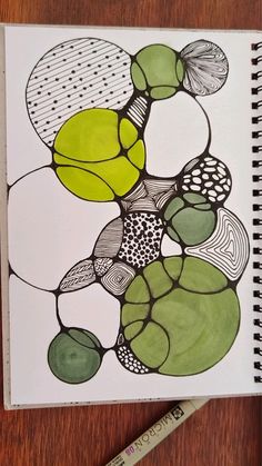 a drawing with green and black circles on it